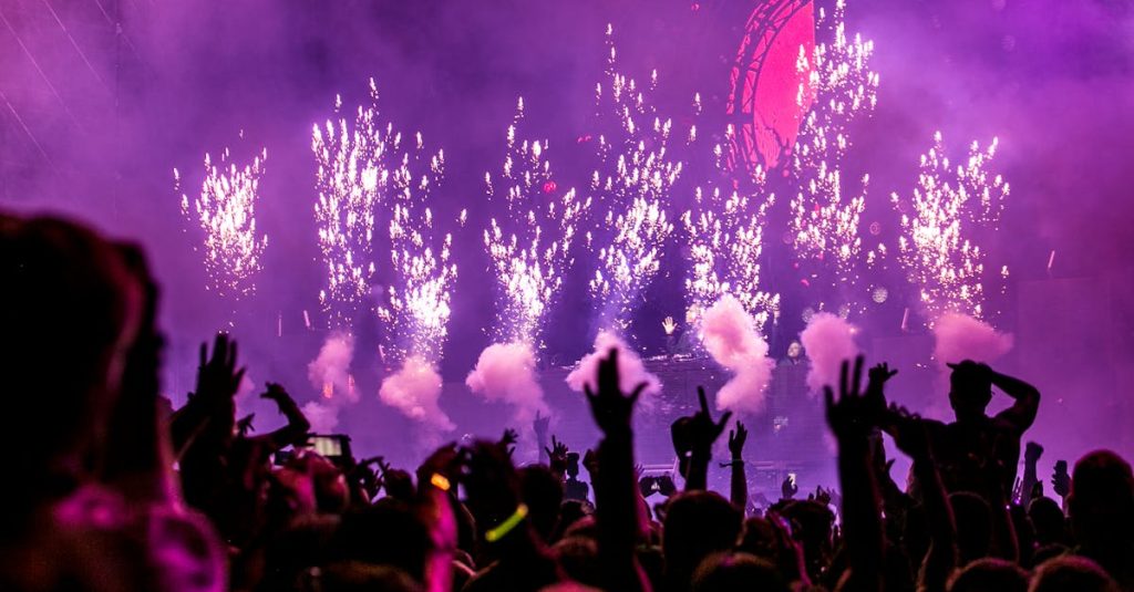 Vibrant EDM concert scene with fireworks, smoke, and enthusiastic crowd enjoying the music.